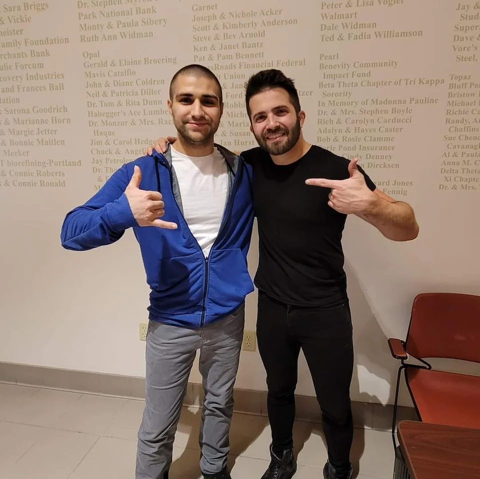 Christopher Jager and Luca Stricagnoli standing side by side after a concert, arms over each other's shoulders, pointing at one another